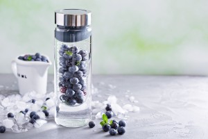 Infused water with mint and blueberries in a bottle
